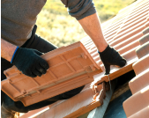 A man laying tile roofing