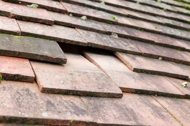 missing tile on a damaged roof